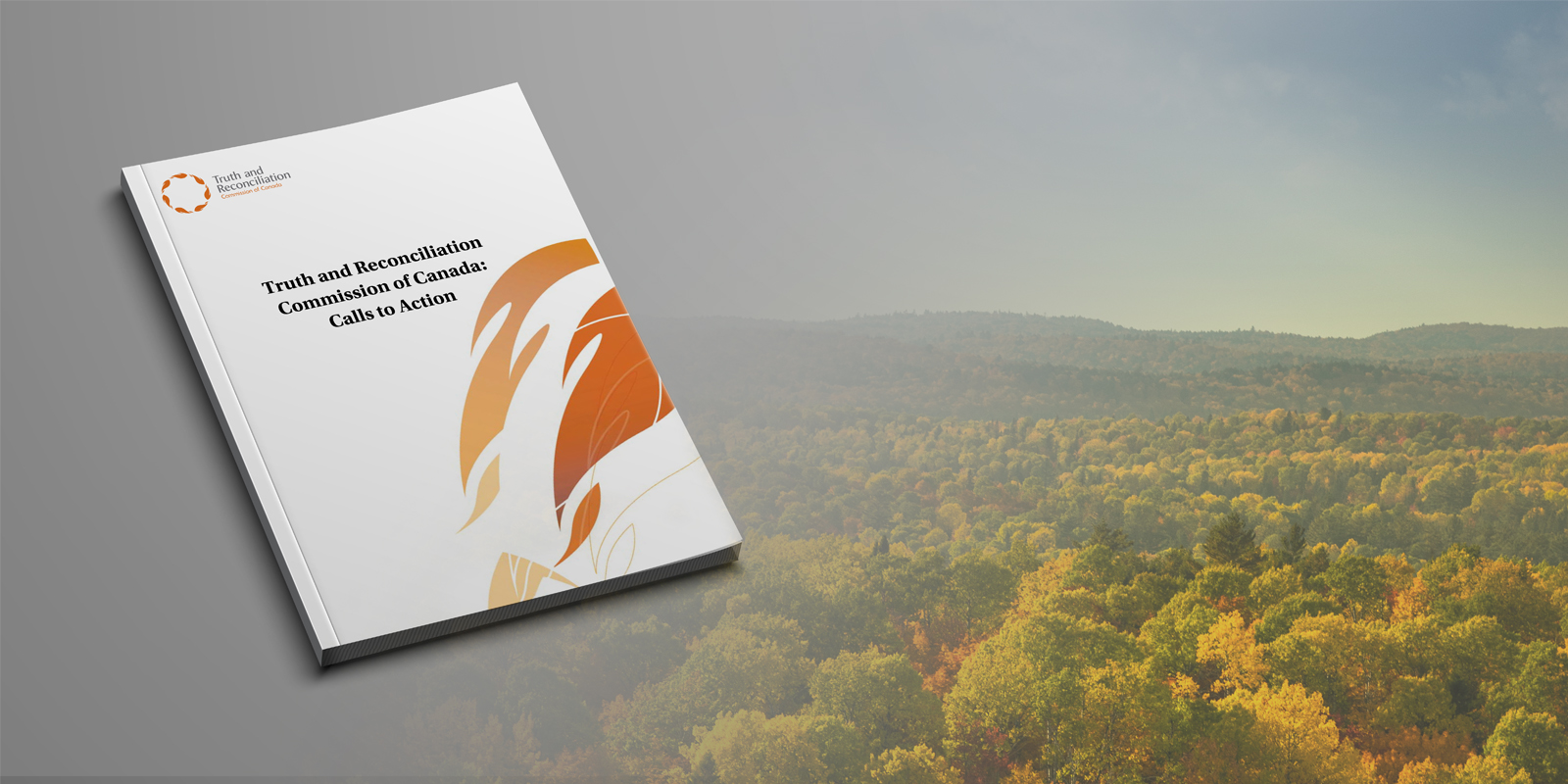 TRC booklet on grey background with northern ontario forest